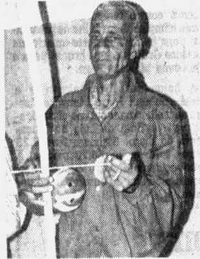 Newspaper photograph of Mestre Canjiquinha holding a berimbau.