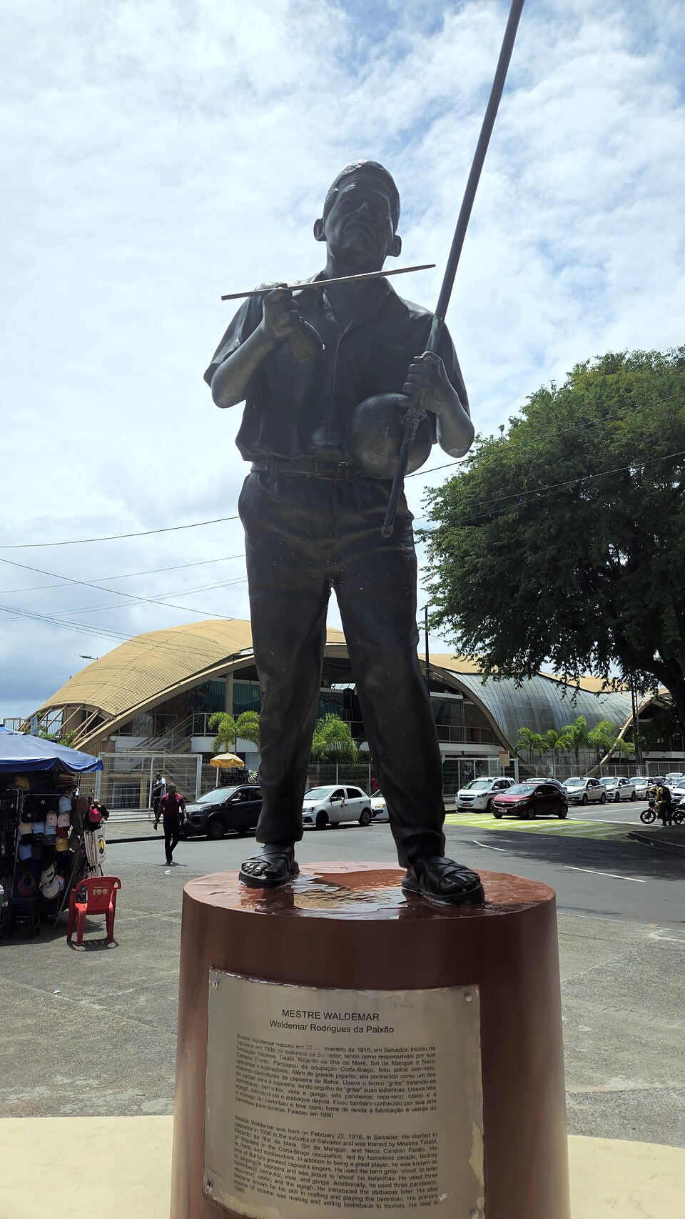 Bronze statue of Mestre Waldemar playing berimbau at Arena da Capoeira in Salvador.